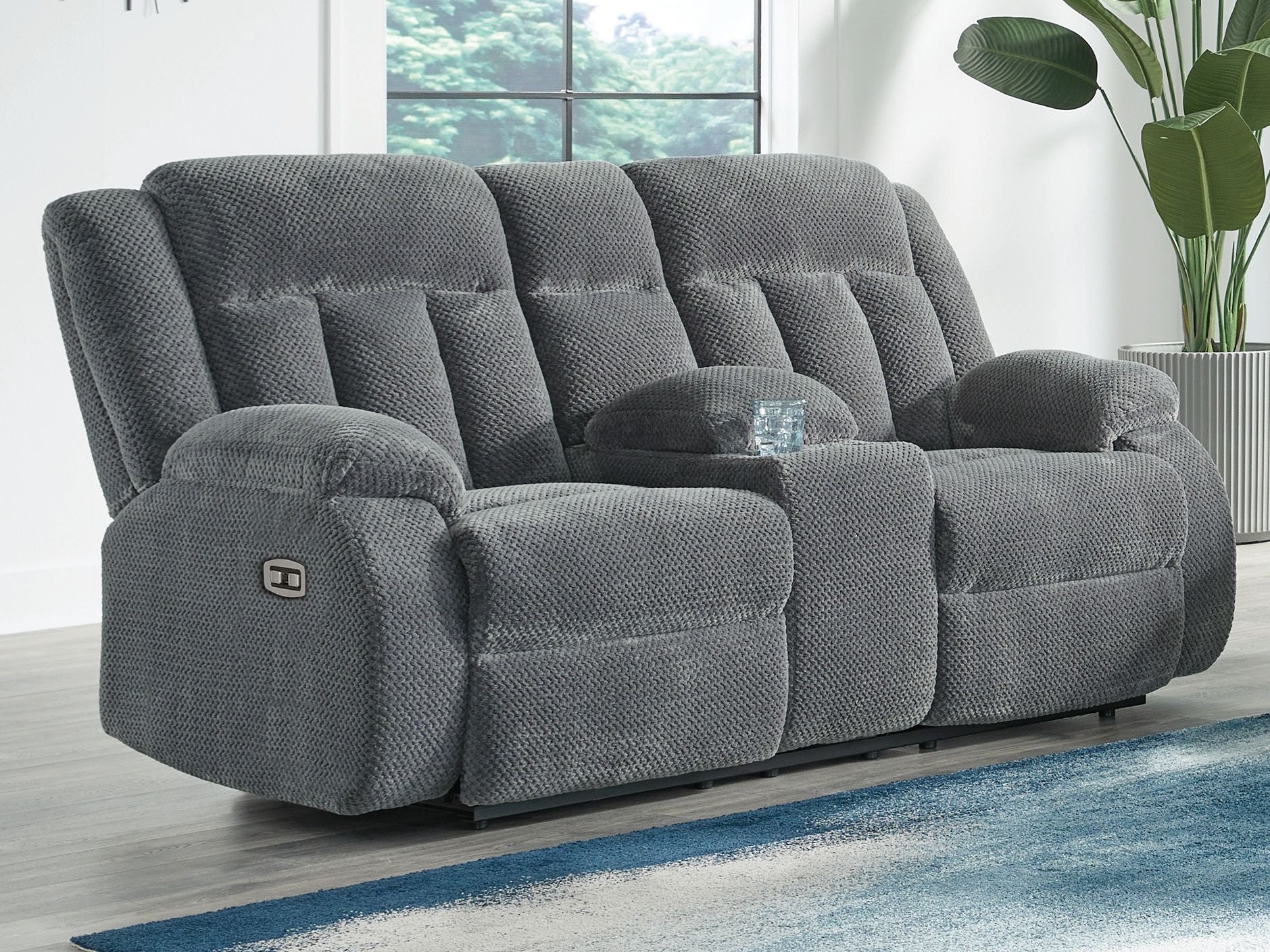 Dark gray double reclining power loveseat with center console and reclining seats