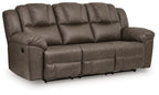 Reclining sofa with tufted back cushions, rounded padded arms, driftwood-toned upholstery
