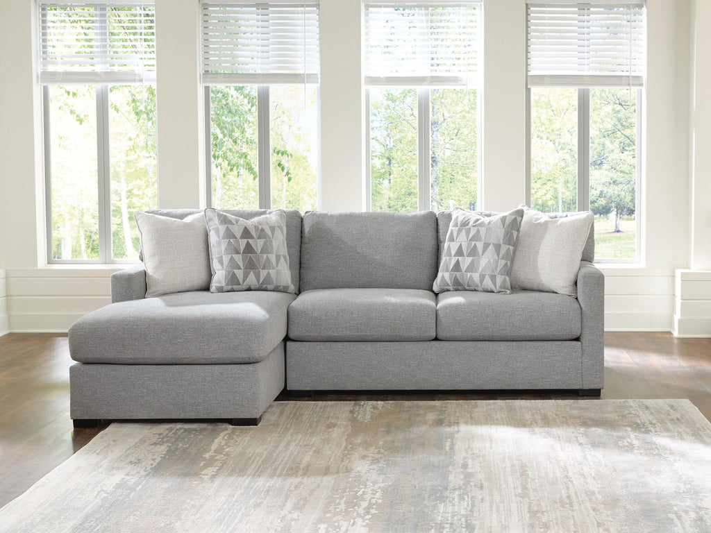 Dark gray sleeper sectional sofa with chaise seat and three geometric accent pillows