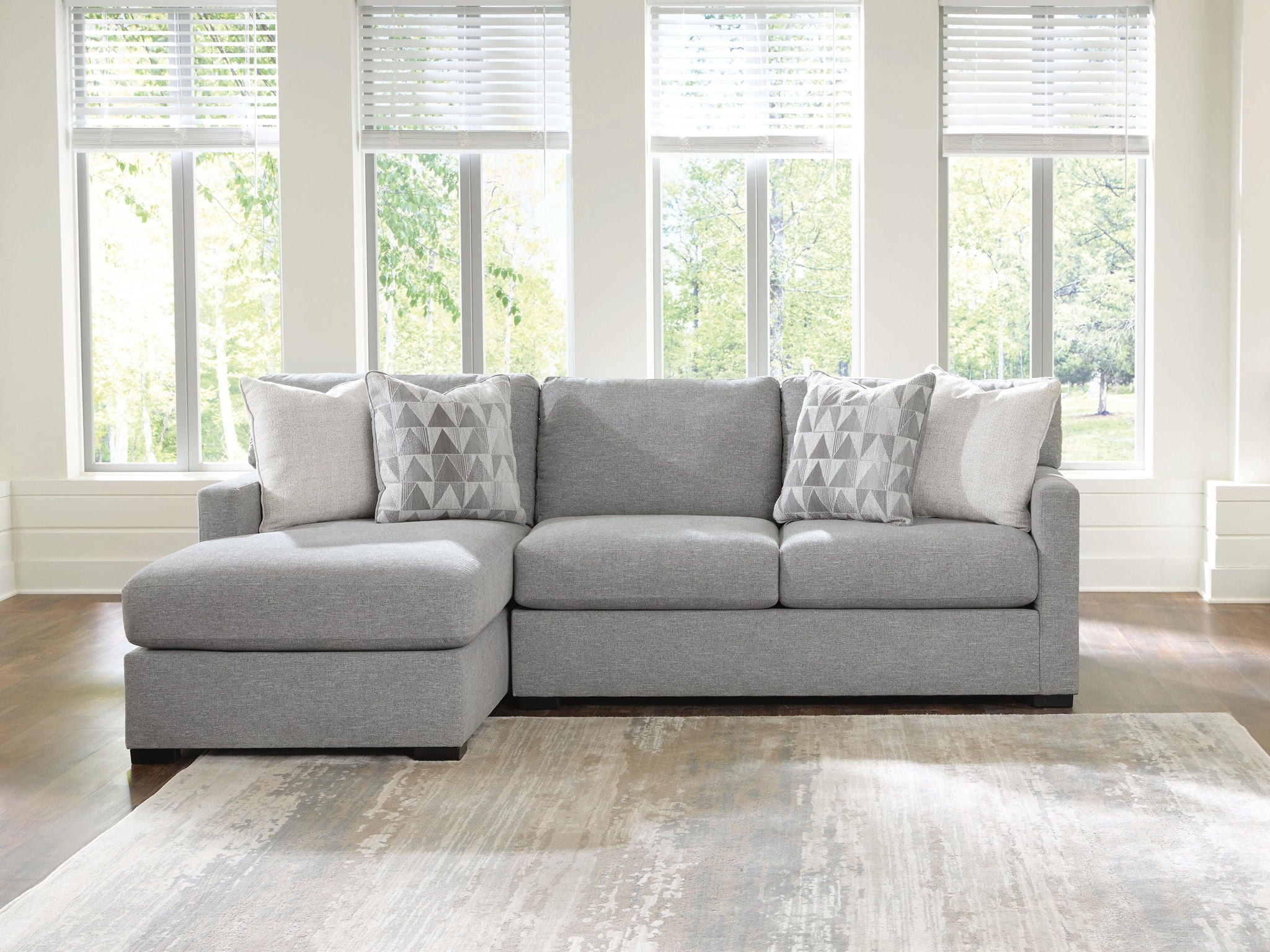 Gray left corner chaise sectional sofa with three patterned throw pillows