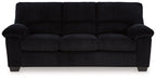 Black corduroy sofa with button-tufted back and rolled armrests
