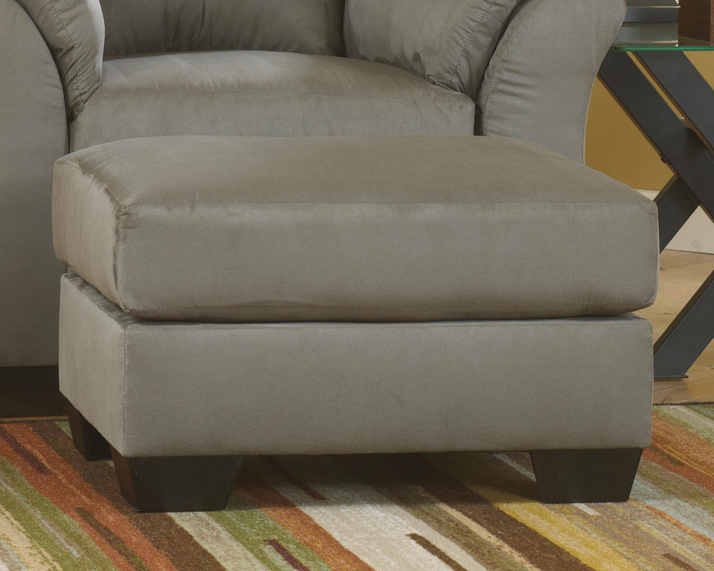 Upholstered ottoman in light gray fabric, padded top and side panels.