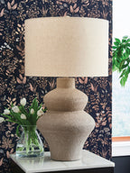 Beige metal table lamp, textured urn-style base with beige drum fabric shade
