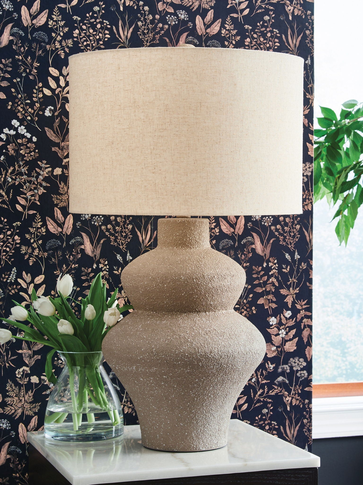 Beige metal table lamp, textured urn-style base with beige drum fabric shade