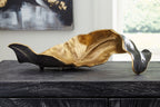 Abstract metal sculpture with gold center and dark black leaf-like form
