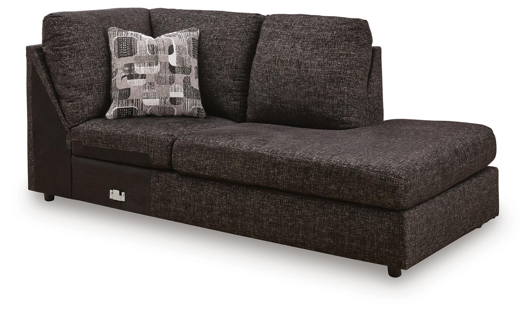 Corner chaise sofa, dark textured fabric, tufted arms, patterned throw pillow, block legs