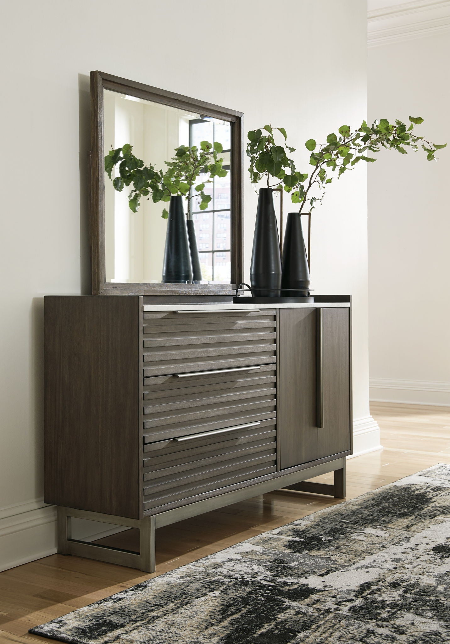 Gray-brown dresser with slatted drawer fronts and tall mirror