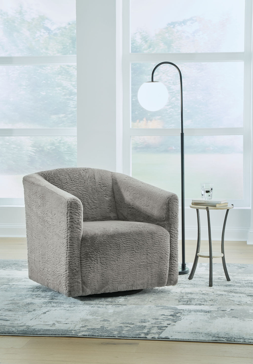 Textured charcoal gray swivel accent chair with rounded arms and back, low profile