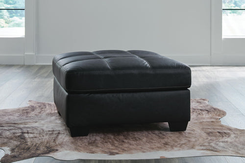 Oversized accent ottoman with tufted top, dark carbon upholstery, and short legs