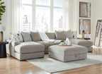 Gray sectional sofa with chaise corner and patterned throw pillows, plus rectangular ottoman
