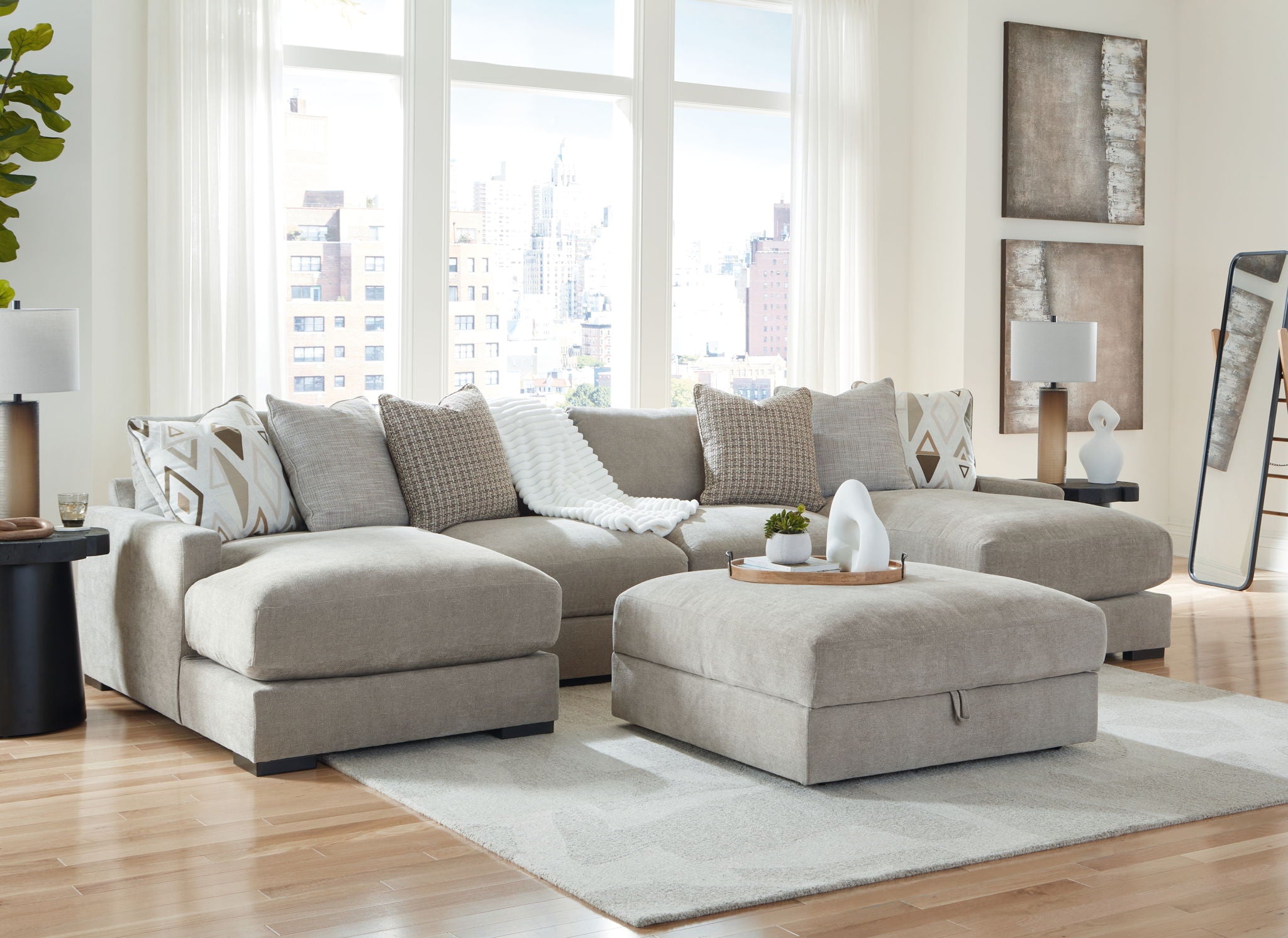 Gray sectional sofa with chaise corner and patterned throw pillows, plus rectangular ottoman