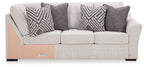 Koralynn Raf sofa with corner wedge, light gray upholstery and patterned cushions
