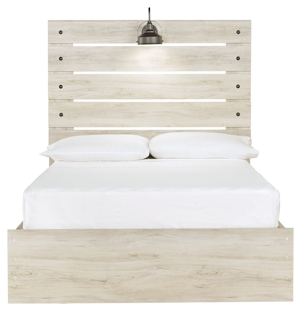 Cambeck panel bed with slatted headboard, beige wood, white pillows and mattress.