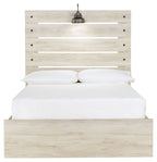 Cambeck panel bed with slatted headboard, beige wood, white pillows and mattress.
