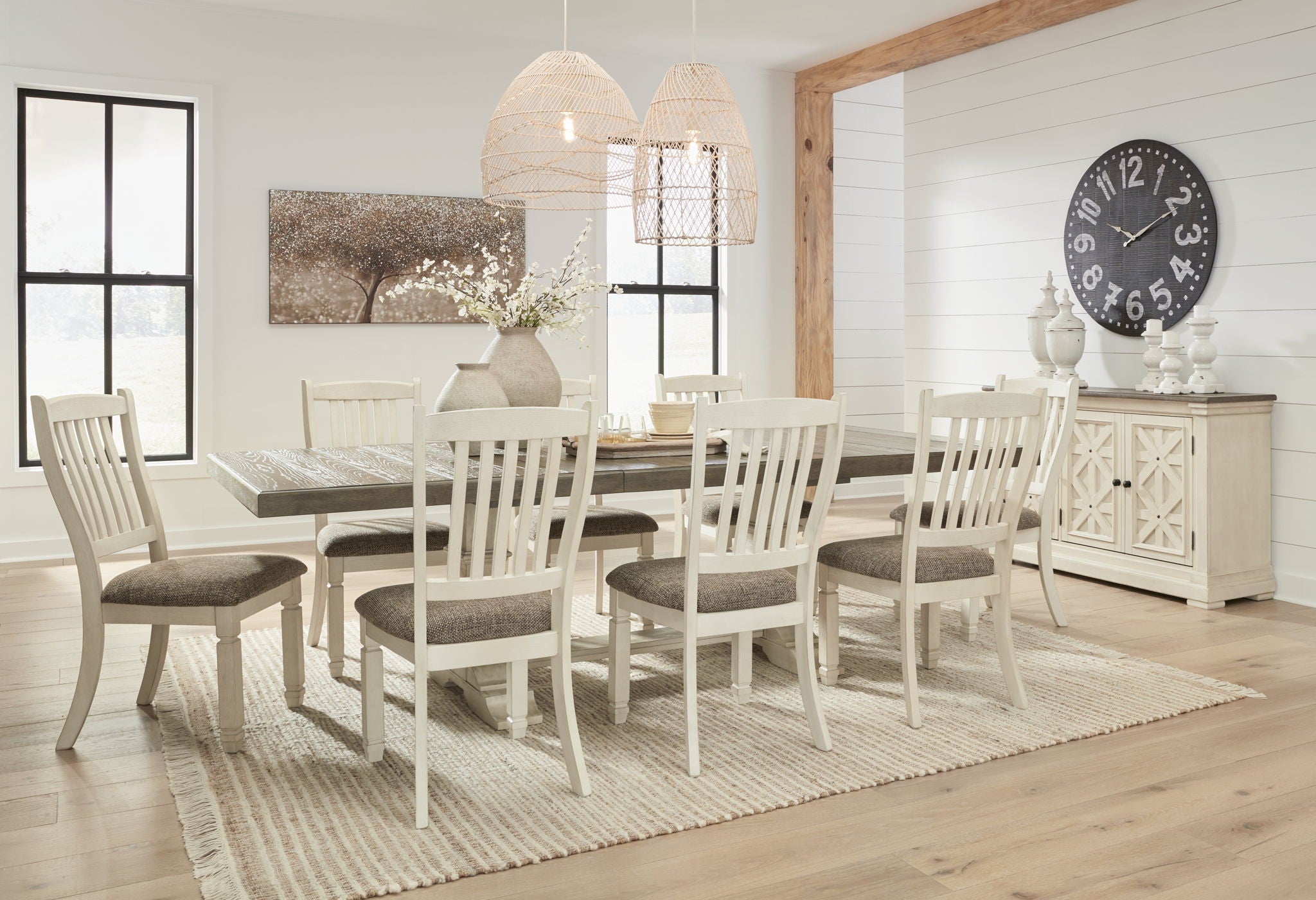 Dining room set with white chairs around table and gray upholstered accents