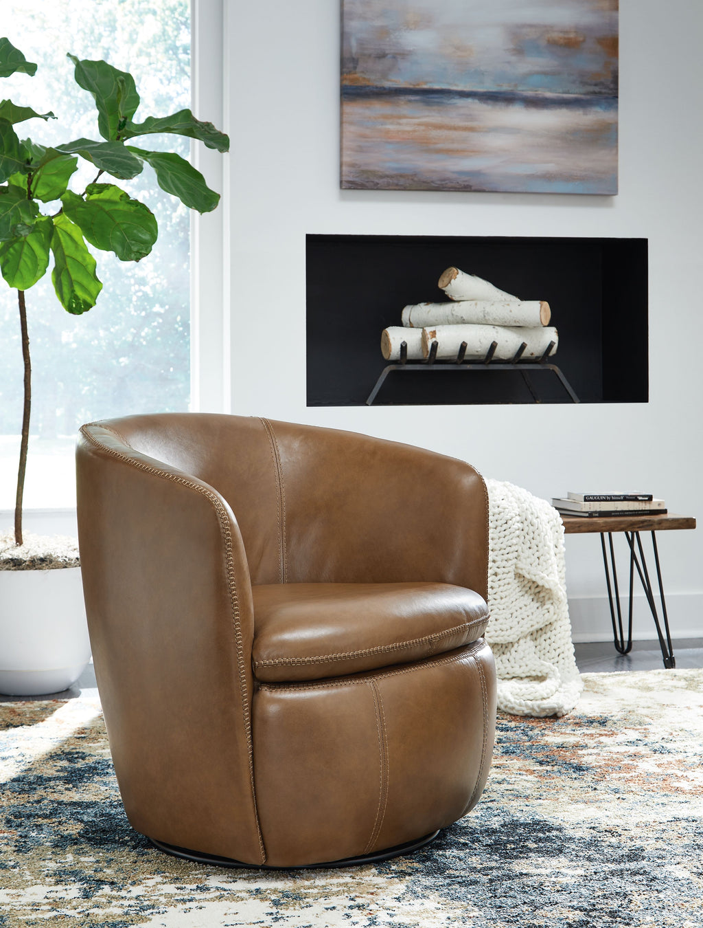 Tan leather-look swivel chair with rounded arms, cushioned seat, and visible swivel base.