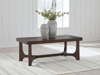 Dark brown rectangular cocktail table with curved apron and sturdy block legs