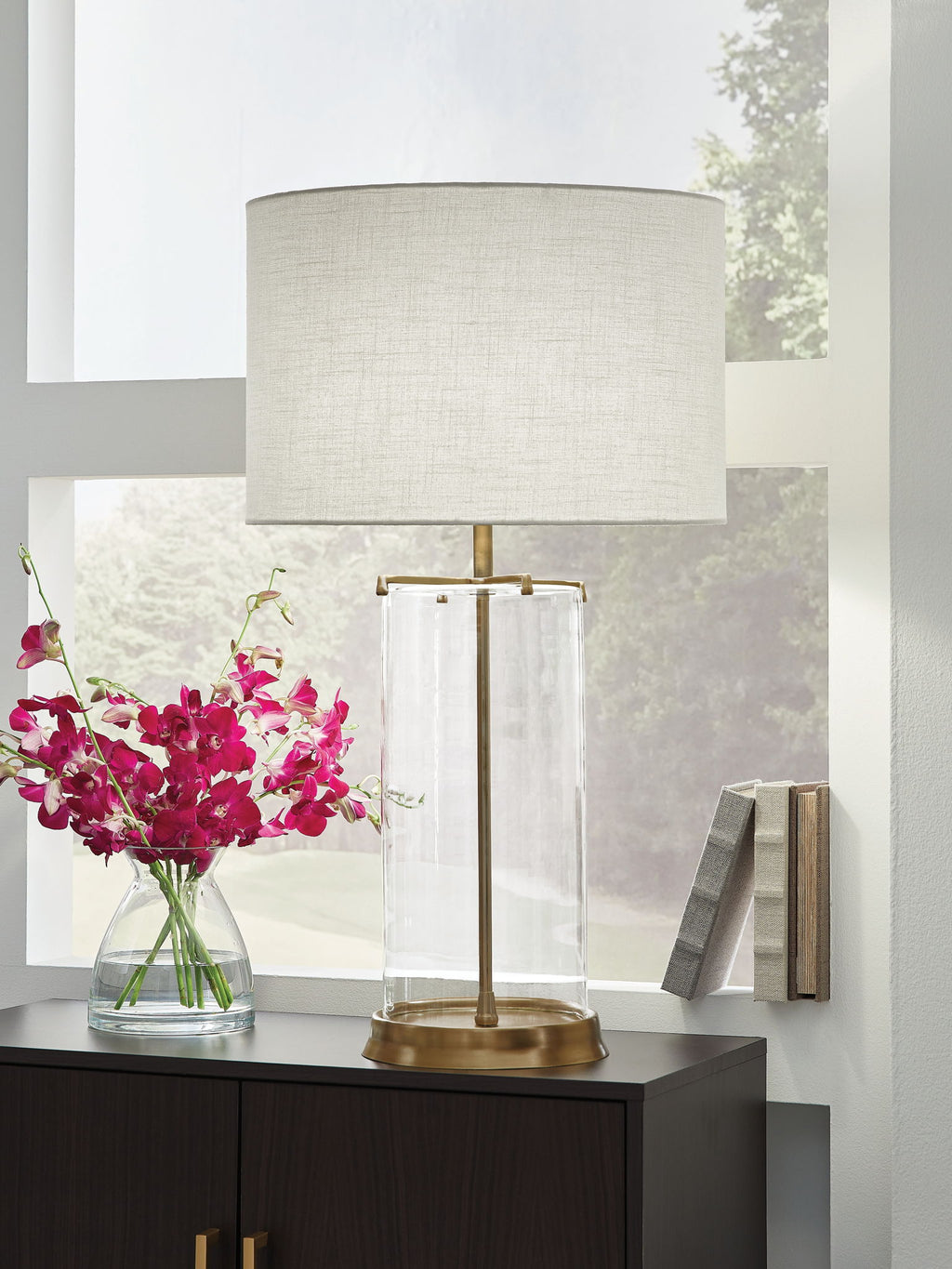 Clear glass table lamp with white fabric shade and gold metal accents