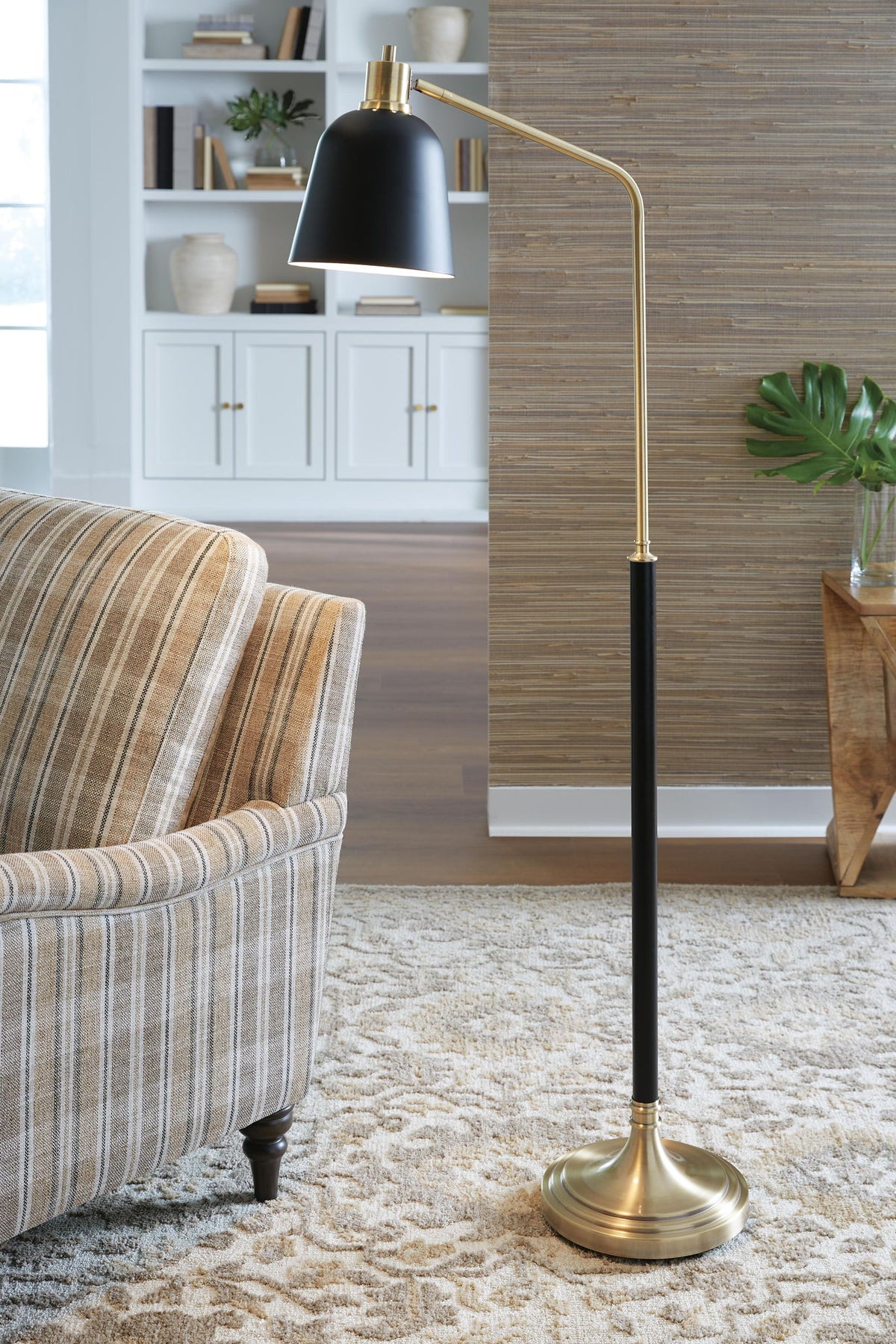 Black cone shade floor lamp with brass stand and round base