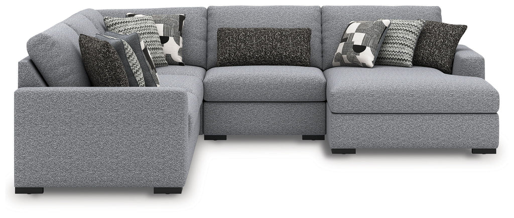Gray sectional sofa with chaise end and patterned decorative throw pillows