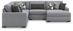 Gray sectional sofa with chaise end and patterned decorative throw pillows