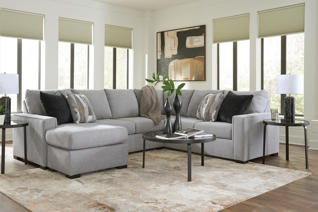 Light gray sectional sofa with chaise and dark striped throw pillows