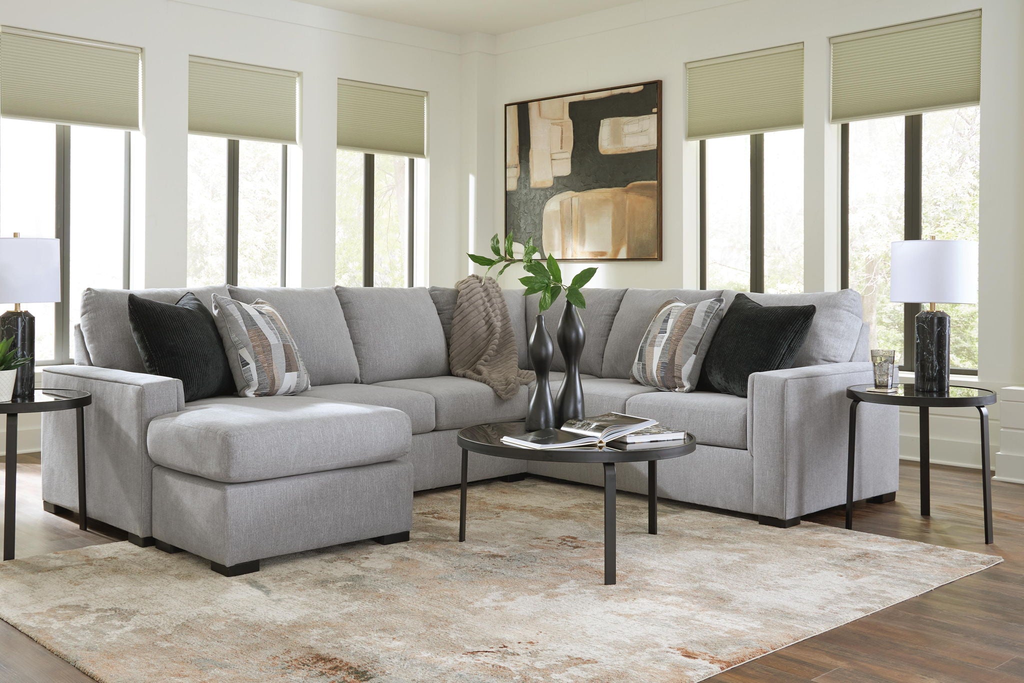Light gray sectional sofa with chaise and dark striped throw pillows