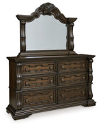 Dark brown dresser with arched mirror and six drawer fronts, ornate woodwork