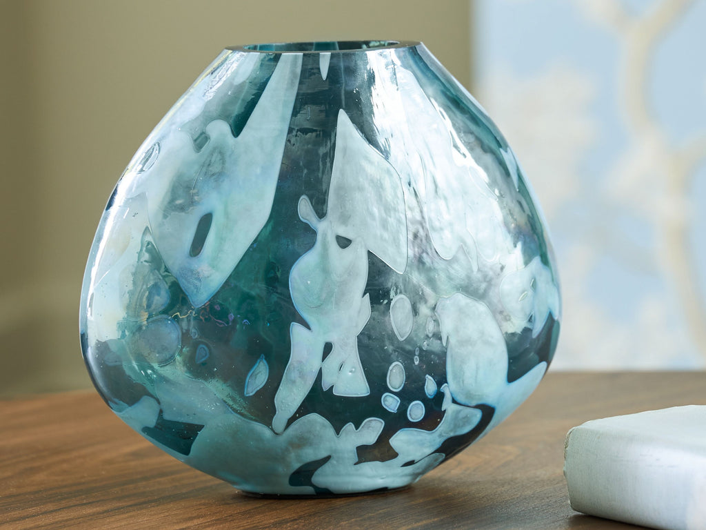 Blue glass vase with flared neck and rounded body, abstract drip-like pattern