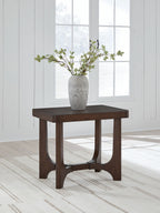 Dark brown rectangular cocktail table with curved apron, shown with a vase on top