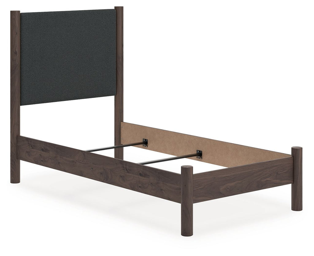 Upholstered panel bed with dark gray headboard and dark brown wood platform base, slats visible