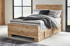 Storage bed with front drawers, light beige wood, black and gray striped blanket on mattress