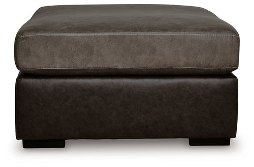 Oversized accent ottoman showing rounded upholstered arms and dark brown base.