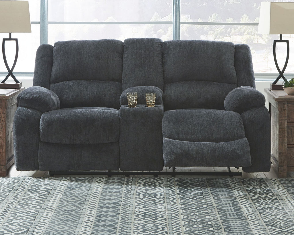 Dark gray reclining loveseat with tall backrest, plush arms, and center console