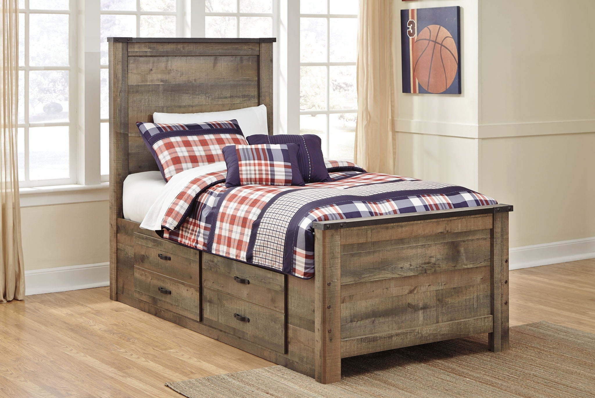 Panel bed with side drawers and navy, red, and white plaid bedding with pillows