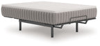 Firm white-top mattress on metal bed frame legs
