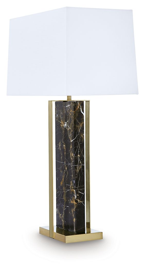 Black marble table lamp with gold base supports and white fabric shade