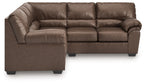 Sectional sofa with brown leather-look upholstery, deep seat, and rounded corner arm