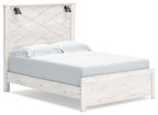 White panel bed with two black wall sconces and slatted headboard, light wood grain