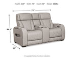 Gray power reclining loveseat with console, quilted armrests, and adjustable headrests