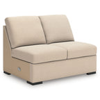 Cream upholstered chaise lounge with two large back cushions and black base legs