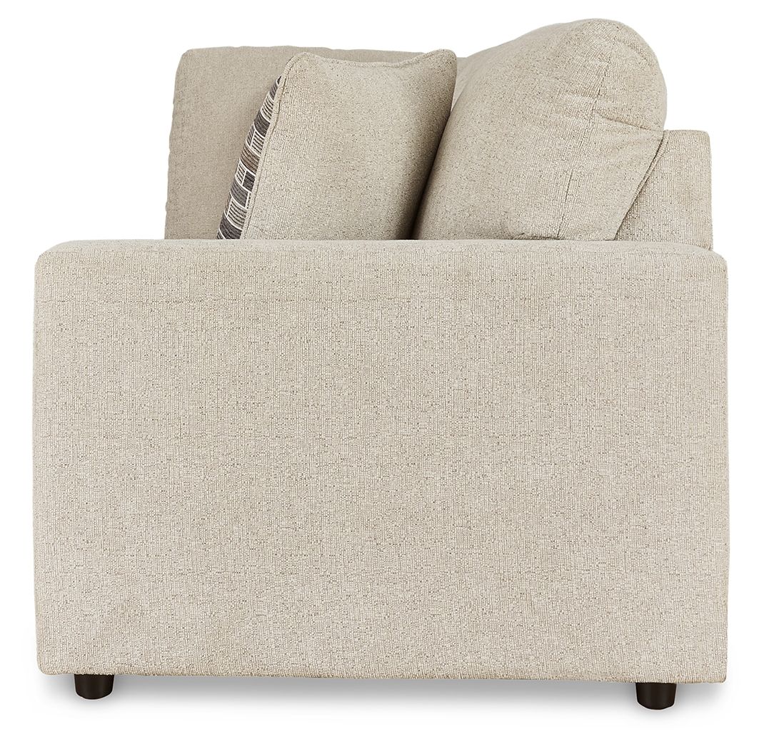 Pearl silver upholstered sofa with curved arms and patterned throw pillow