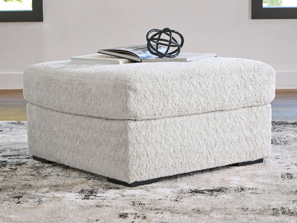 Light gray oversized accent ottoman with rounded top and black base feet