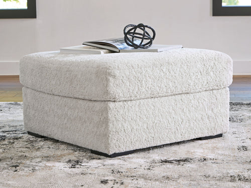 Light gray oversized accent ottoman with rounded top and black base feet