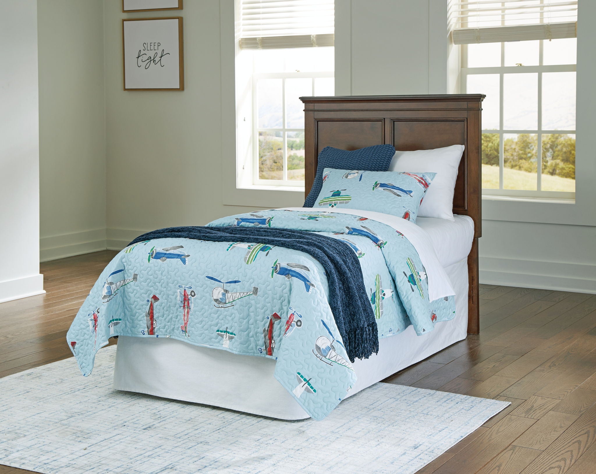 Brown twin panel headboard with two raised panels behind a white bed frame