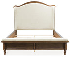 Upholstered panel bed with cream upholstered headboard, dark brown wood posts and slats