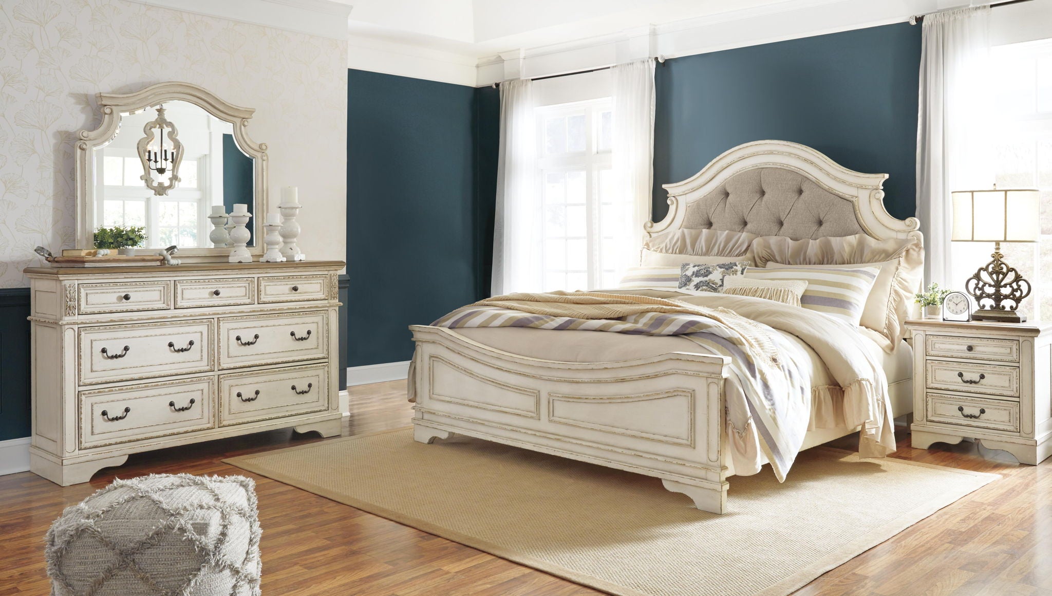 White dresser with mirror and six drawers, shown with bed in matching bedroom style.