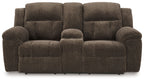 Dark brown double reclining loveseat with rounded arms and tufted back cushions
