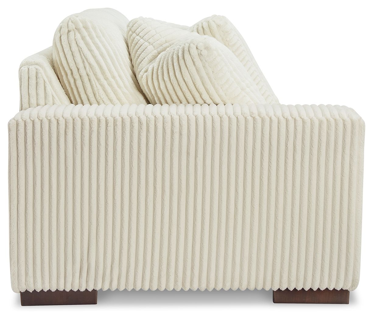 Ivory corner chair with ribbed upholstery, tufted back, and armrests