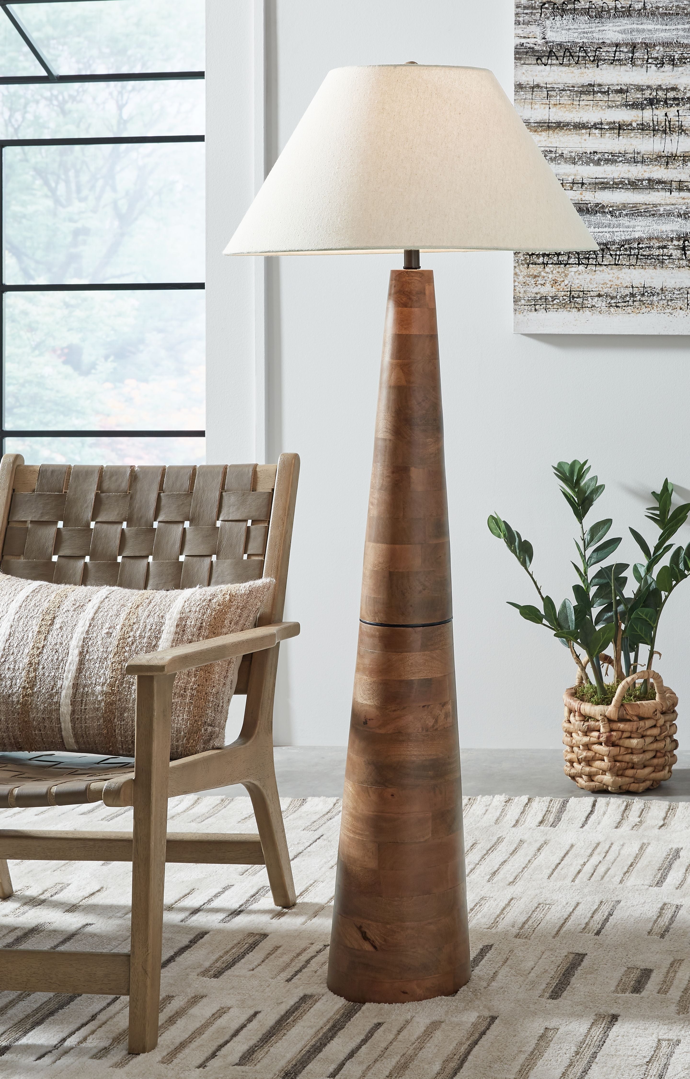 Floor lamp with off-white fabric shade and dark brown tapered wood pedestal base